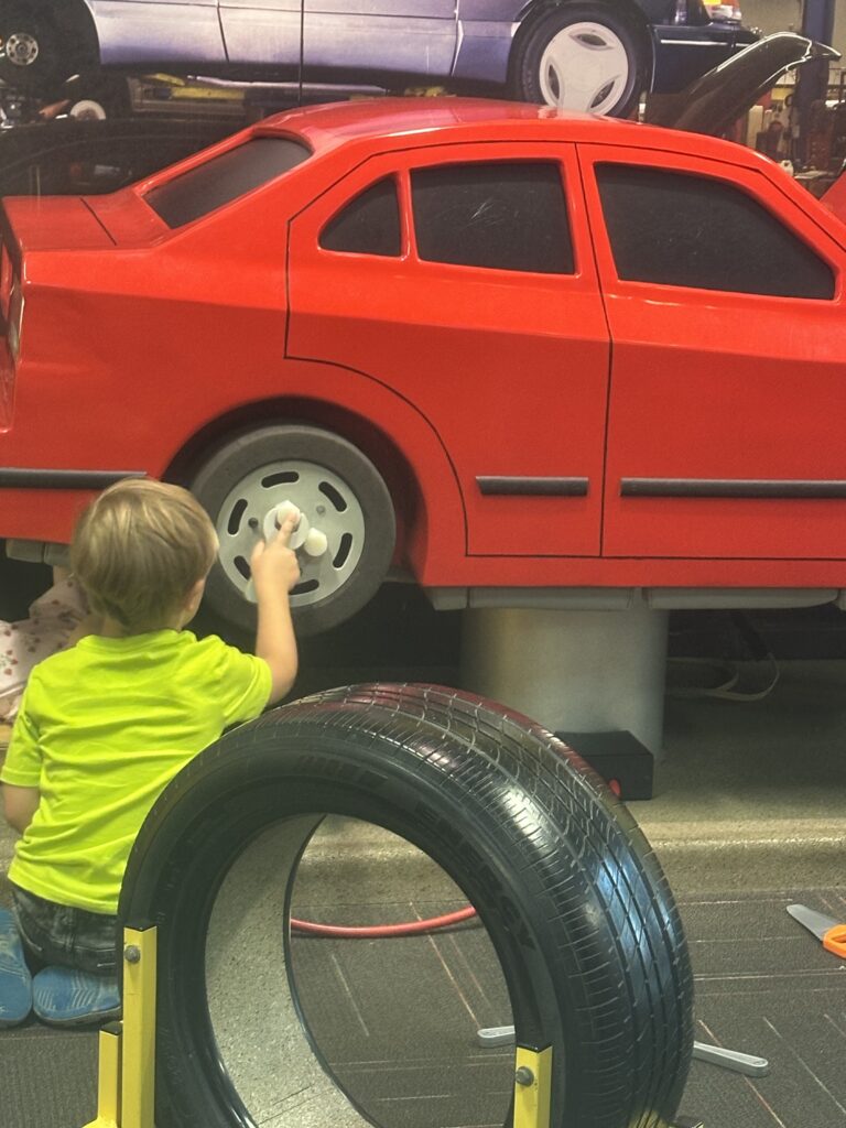 little boy working on car
