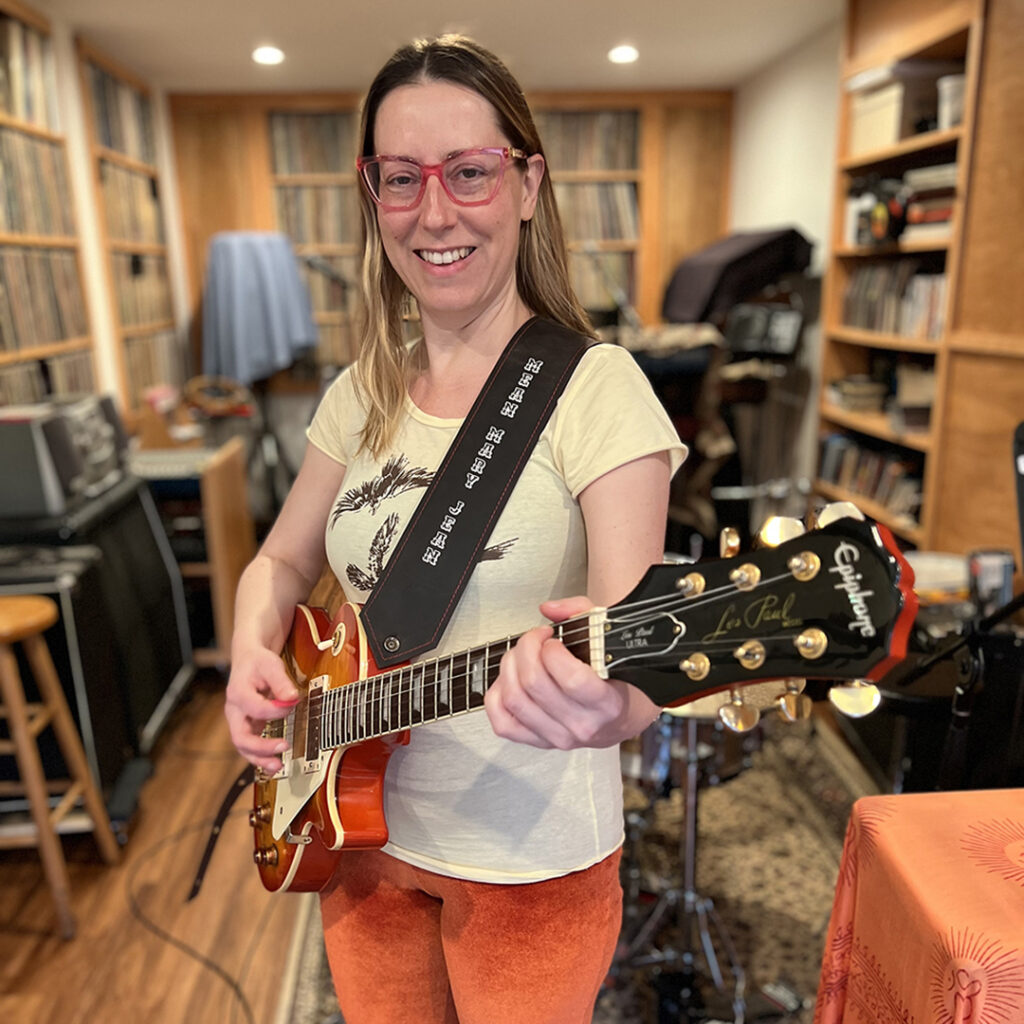Photo of Mary playing guitar
